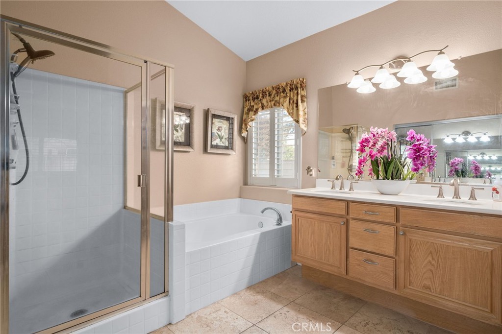 9403 Old Post Drive Rancho Cucamonga, CA 91730 - Photo 22 of 38 a bathroom with a tub a sink and mirror