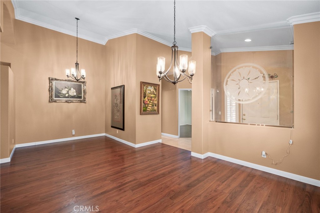 9403 Old Post Drive Rancho Cucamonga, CA 91730 - Photo 9 of 38 a view of a room with wooden floor chandelier and entryway