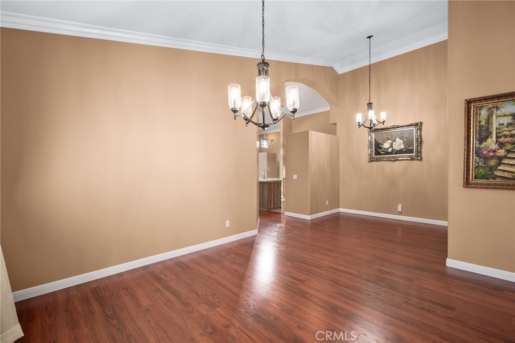 9403 Old Post Drive Rancho Cucamonga, CA 91730 - Photo 10 of 38 a view of a chandelier fan and wooden floor