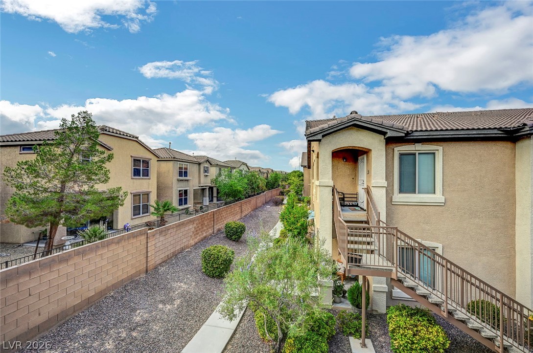 8985 South Durango Drive, Unit 2187 Las Vegas, NV 89113 - Photo 37 of 73 Discover a charming stucco exterior with a durable tile roof, offering lasting appeal and low maintenance.