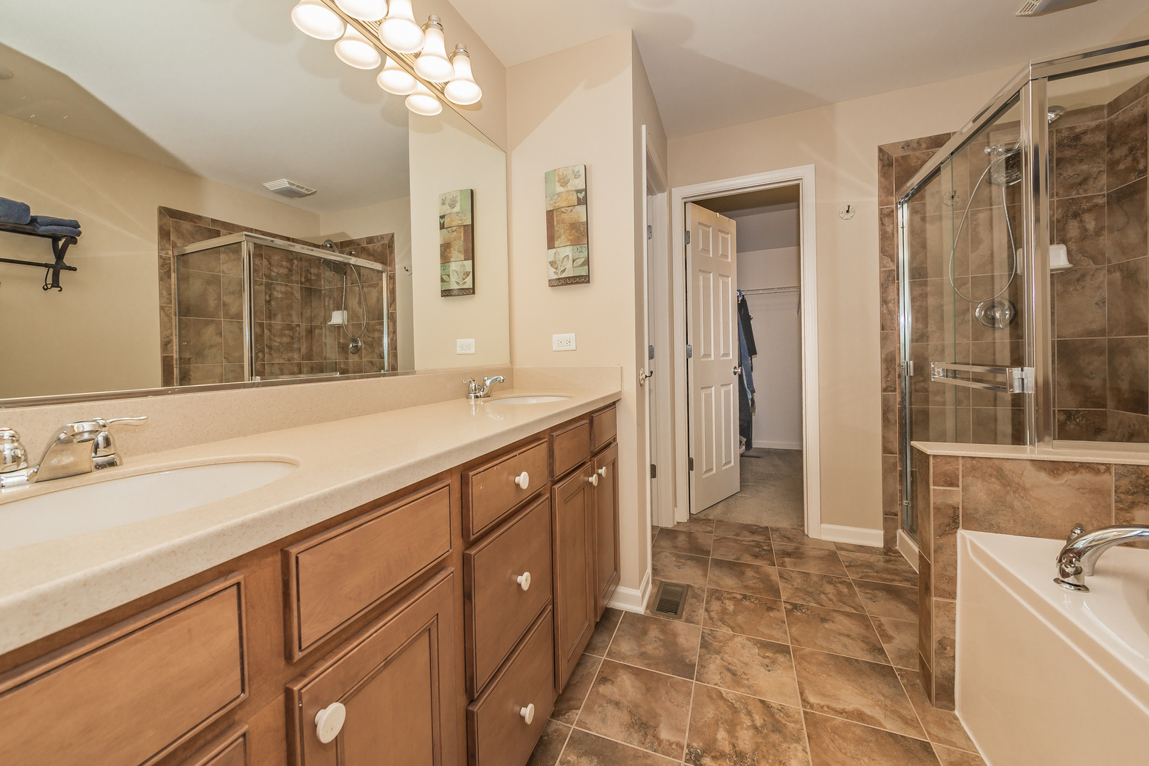 183 Reston Lane Gilberts, IL 60136 - Photo 20 of 26 a spacious bathroom with a shower sink double vanity and a mirror