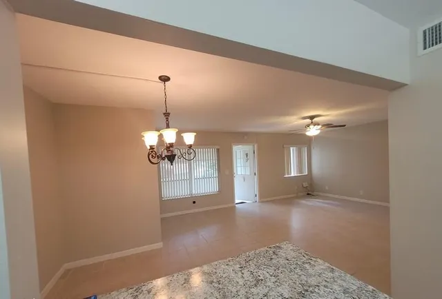 a view of a livingroom with a ceiling fan and window