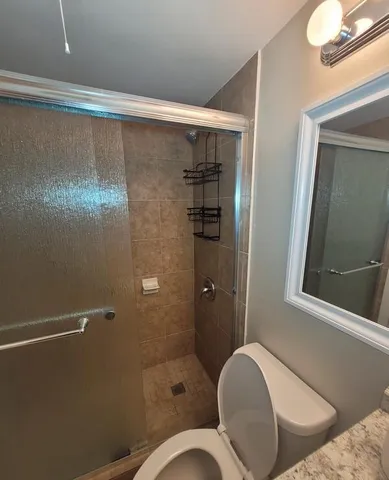 a backyard of a house with table and chairs under an umbrella