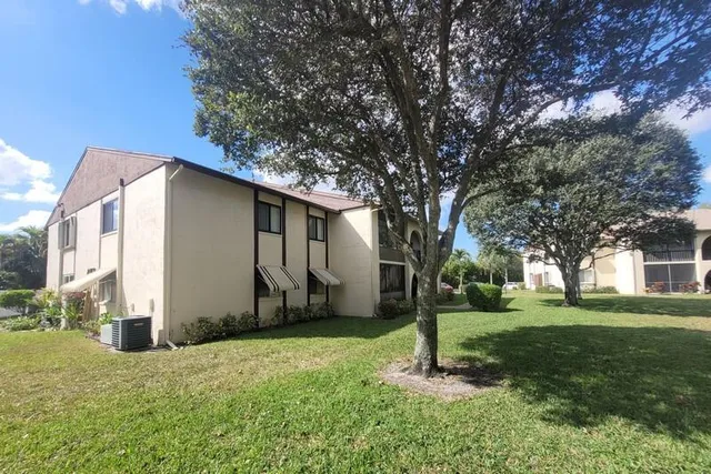a view of a house with backyard and sitting area