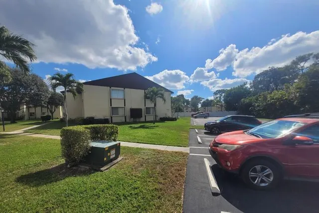 a view of a chair and table in the backyard of a house