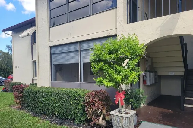 a view of an empty room with a chandelier fan