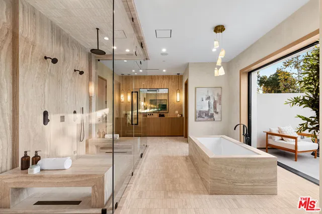 a large spacious bathroom with a large tub shower and sink