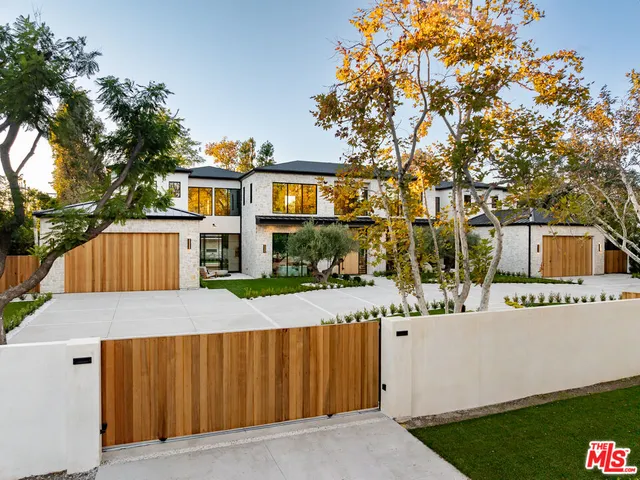 a view of a house with a wrought fence