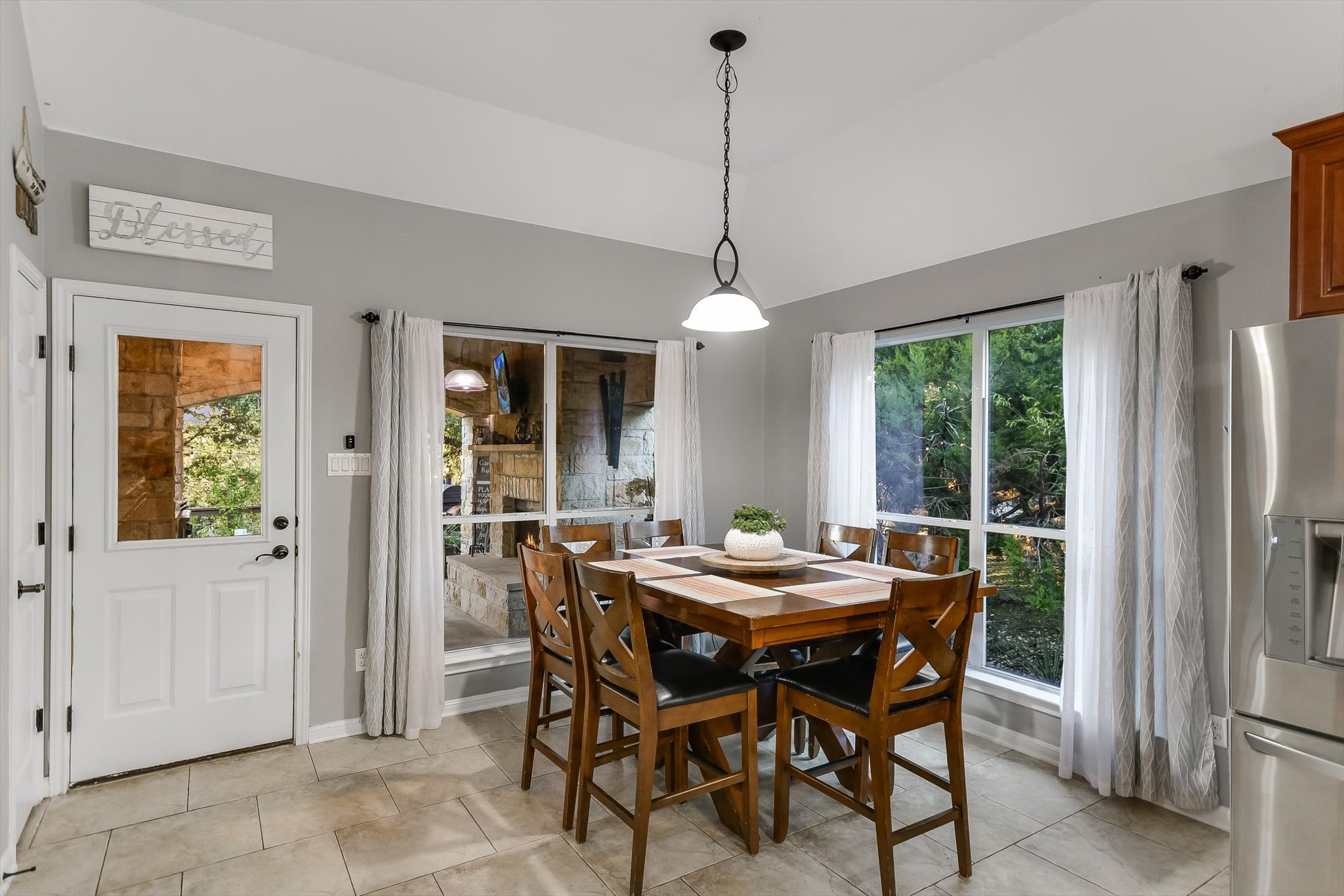 300 Wesley Ridge Drive Spicewood, TX 78669 - Photo 15 of 40 The breakfast nook offers a cozy spot to enjoy your morning coffee, framed by large windows and easy access to the deck.