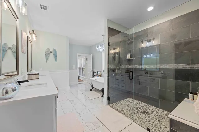 a bathroom with a sink a toilet and shower