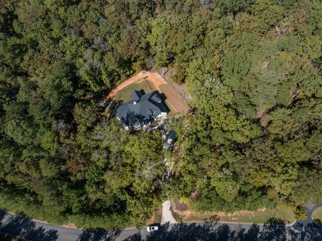 an aerial view of a house with a yard