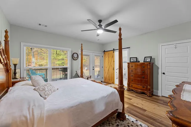 a bedroom with a large bed and a flat tv screen