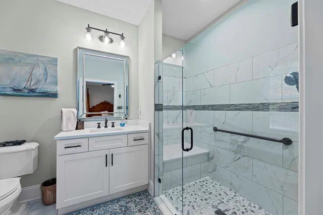 a bathroom with a toilet sink and mirror