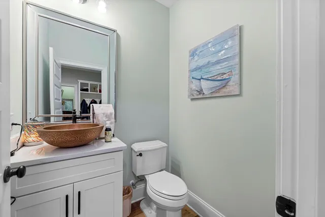 a bathroom with a toilet a sink and mirror