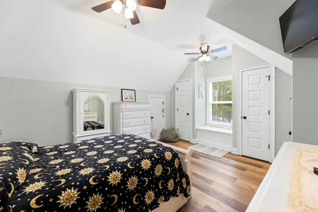a bedroom with a large bed and a chandelier