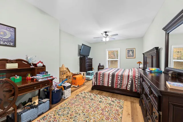 a bedroom with bed and a flat tv screen
