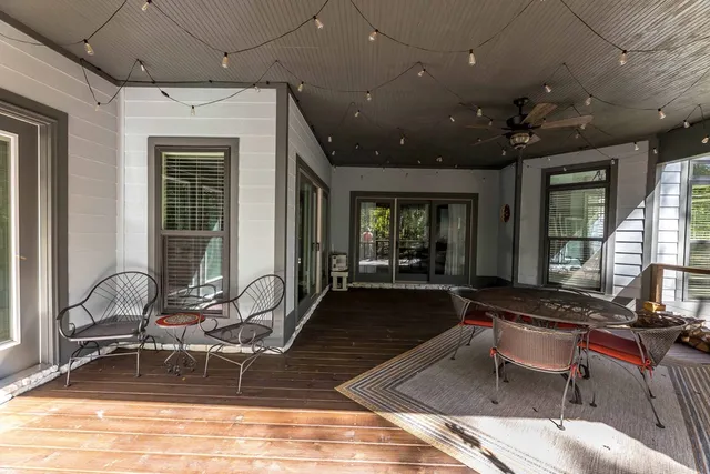 a room with gym equipment and large windows