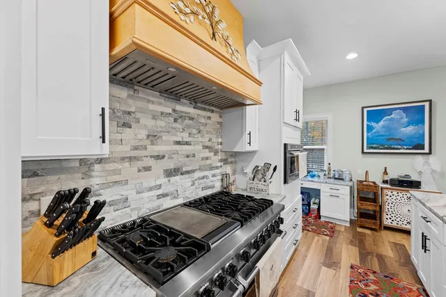 a stove top oven sitting inside of a kitchen