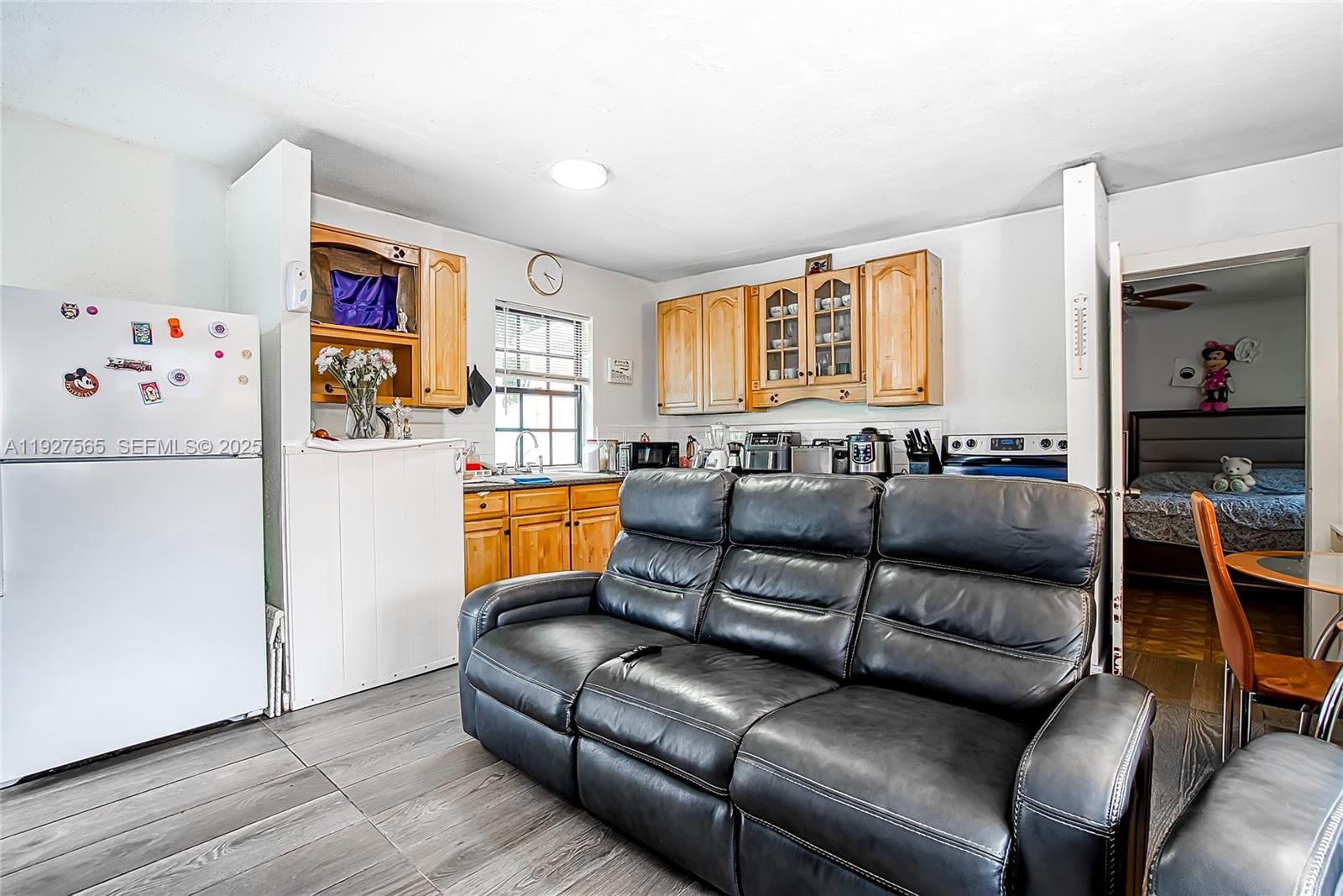 2516 Cleveland Street Hollywood, FL 33020 - Photo 12 of 42 a living room with furniture and a refrigerator