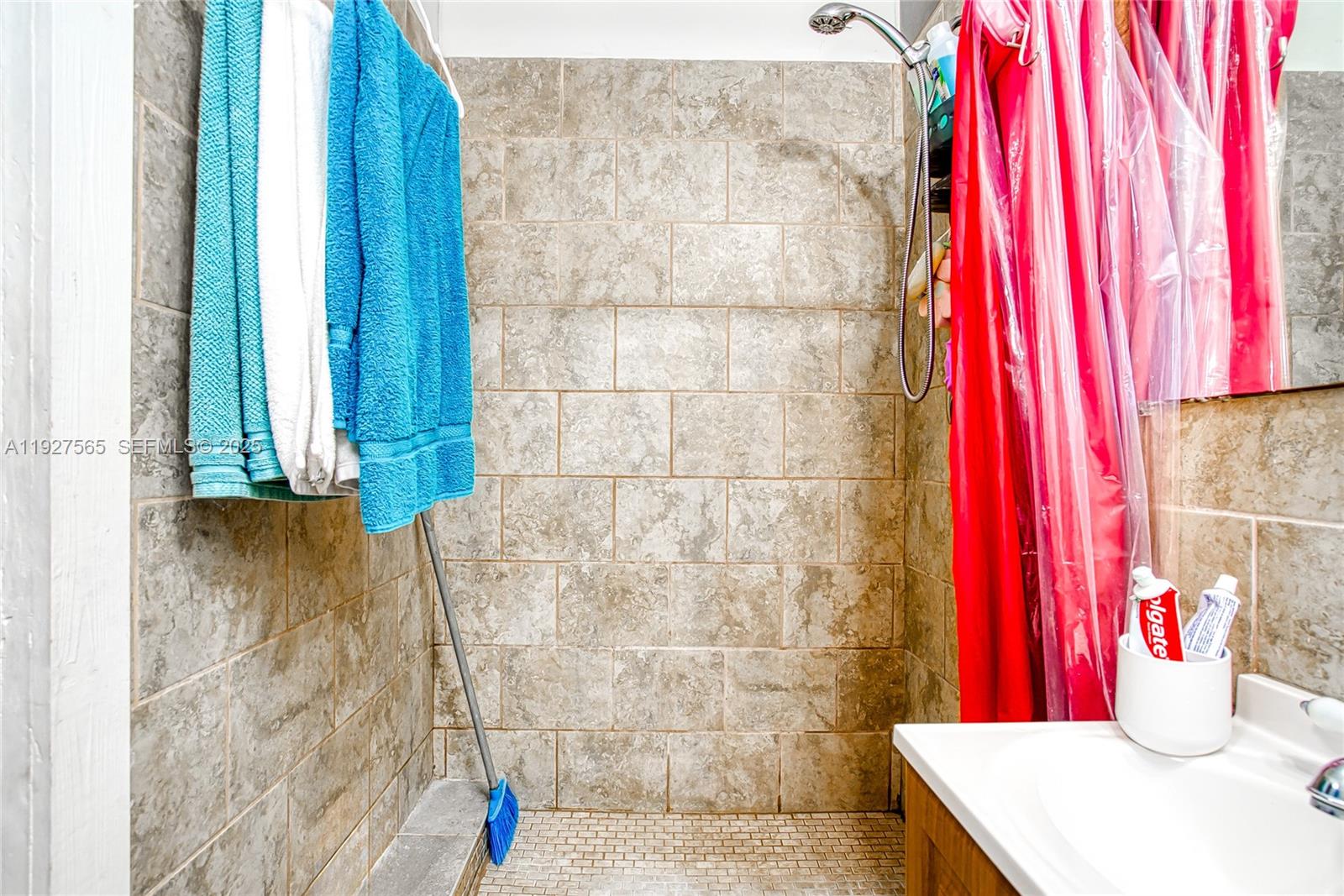 2516 Cleveland Street Hollywood, FL 33020 - Photo 15 of 42 a bathroom with a shower curtain and a sink