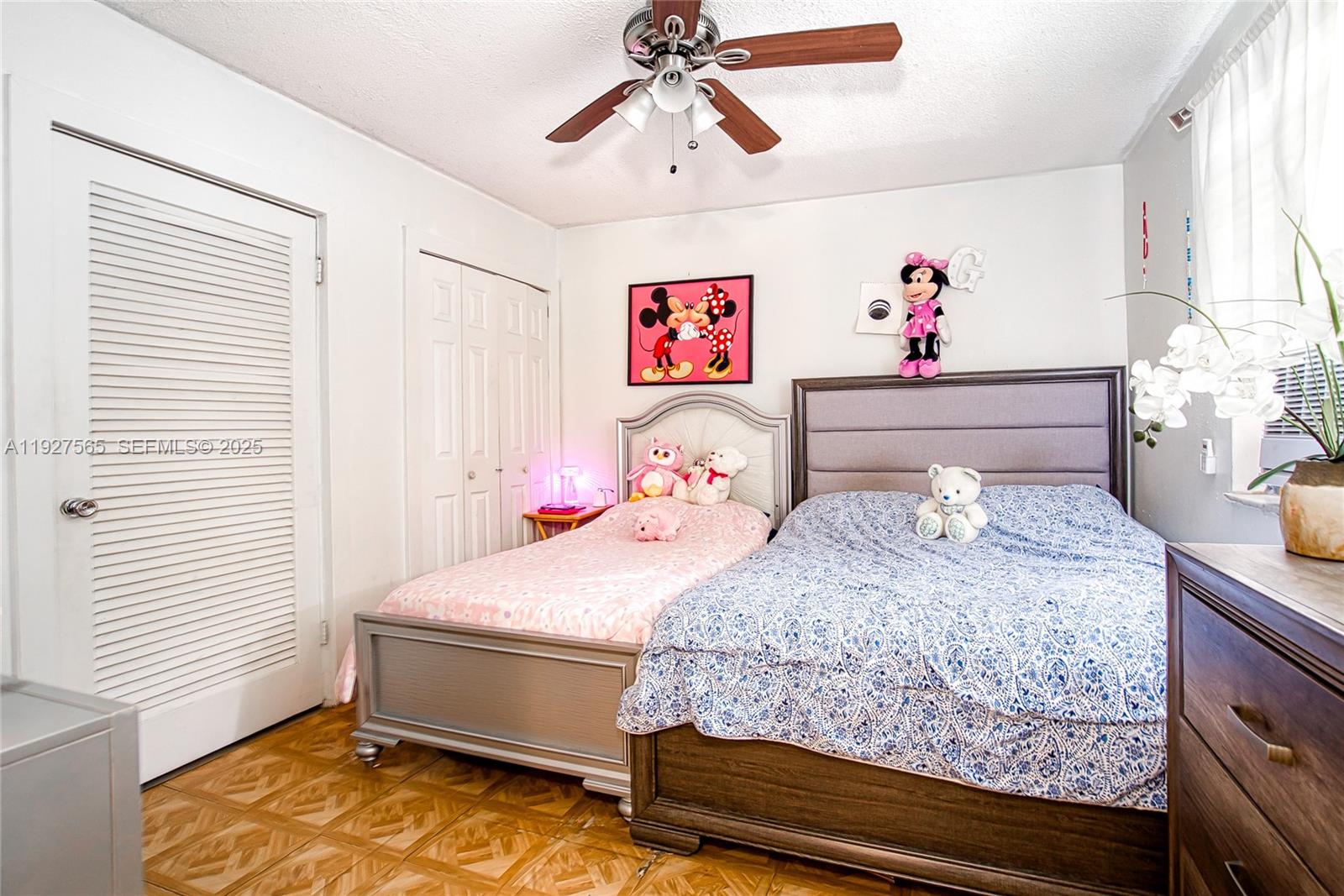 2516 Cleveland Street Hollywood, FL 33020 - Photo 17 of 42 a bedroom with a bed and a chandelier