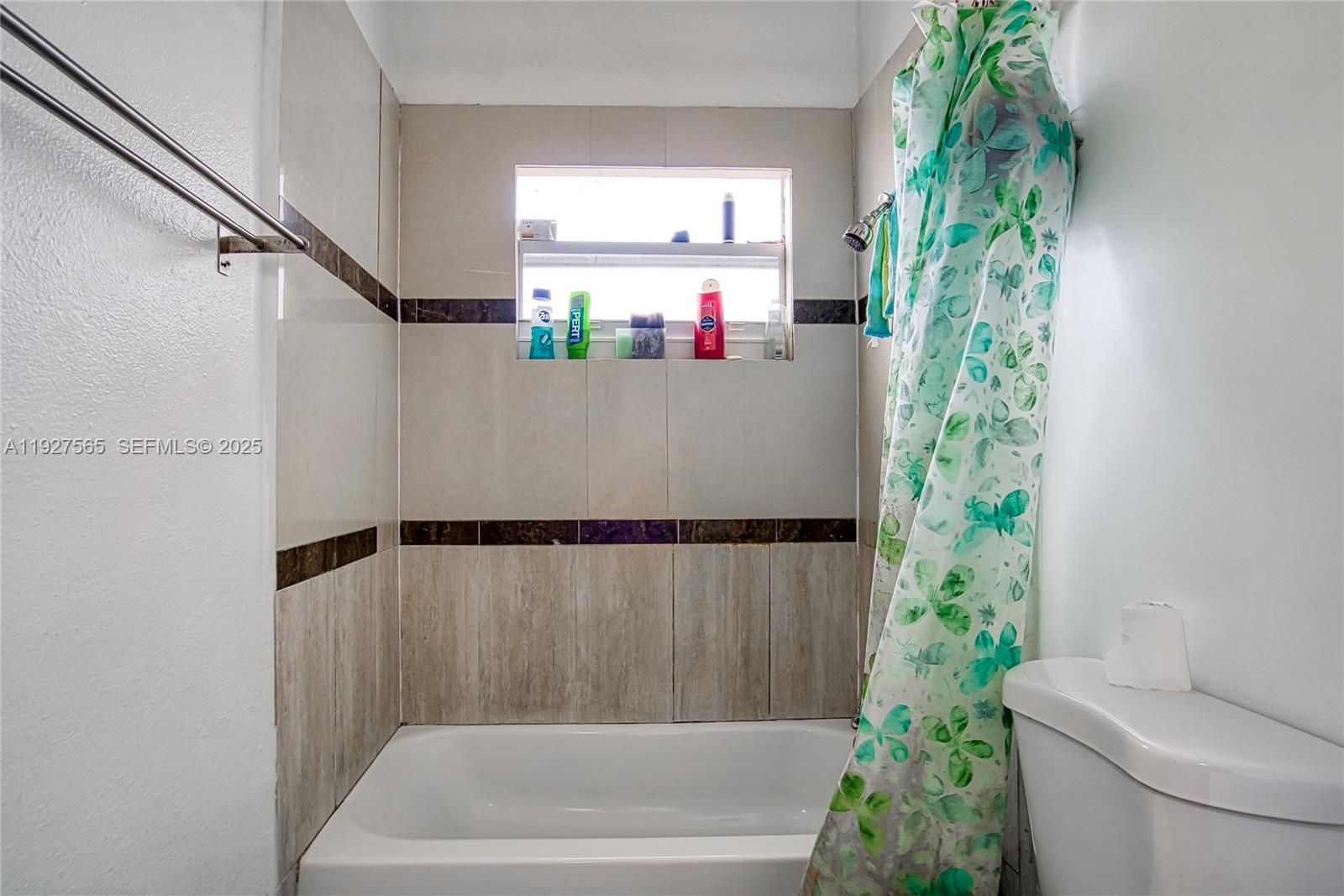2516 Cleveland Street Hollywood, FL 33020 - Photo 20 of 42 a bathroom with a bathtub and shower curtain
