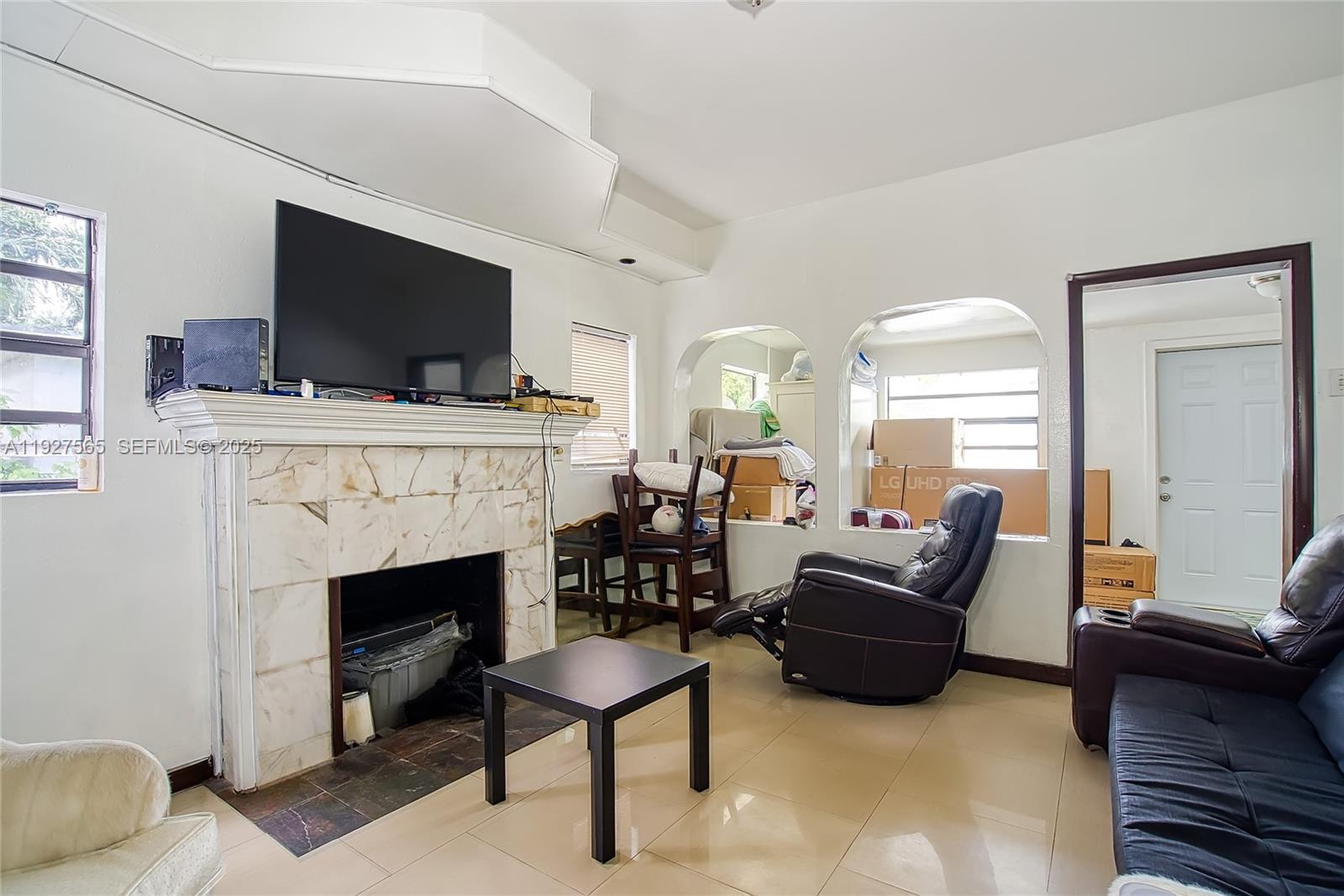 2516 Cleveland Street Hollywood, FL 33020 - Photo 2 of 42 a living room with furniture a fireplace and a flat screen tv