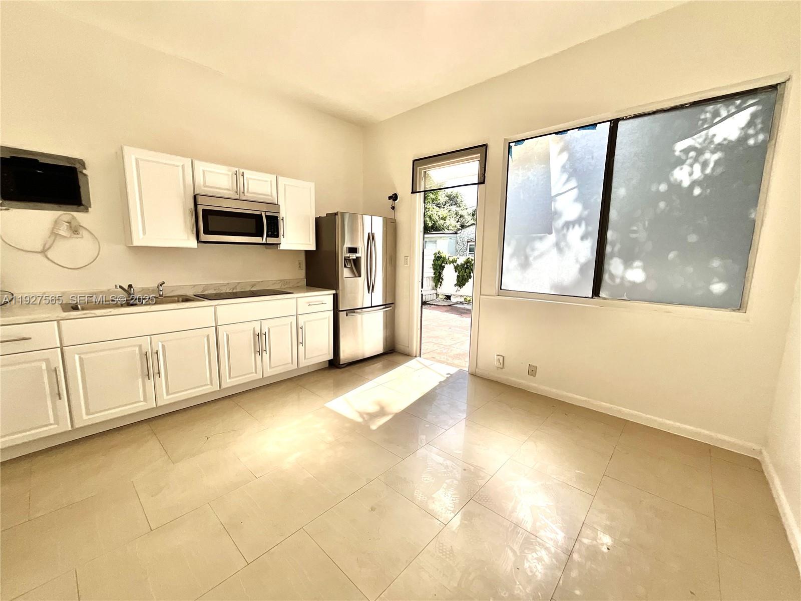 2516 Cleveland Street Hollywood, FL 33020 - Photo 30 of 42 a view of a kitchen with a sink cabinet and a microwave