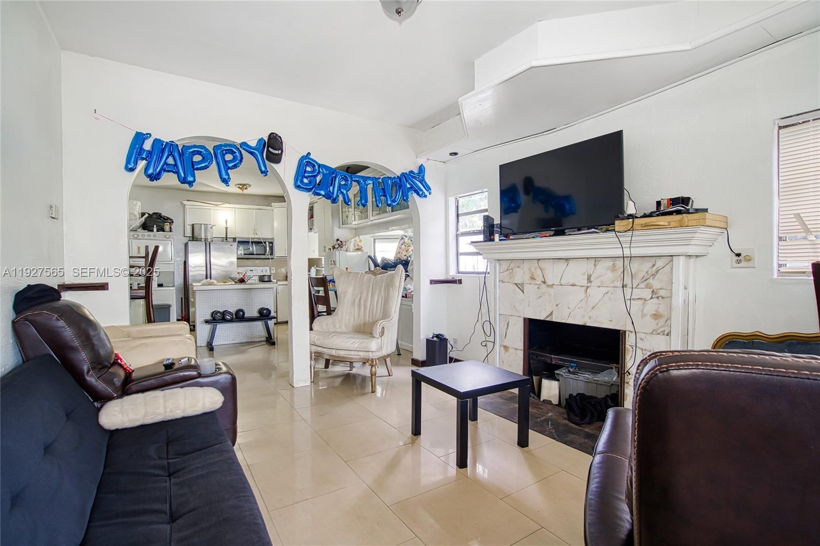 2516 Cleveland Street Hollywood, FL 33020 - Photo 3 of 42 a living room with furniture a flat screen tv and a fireplace