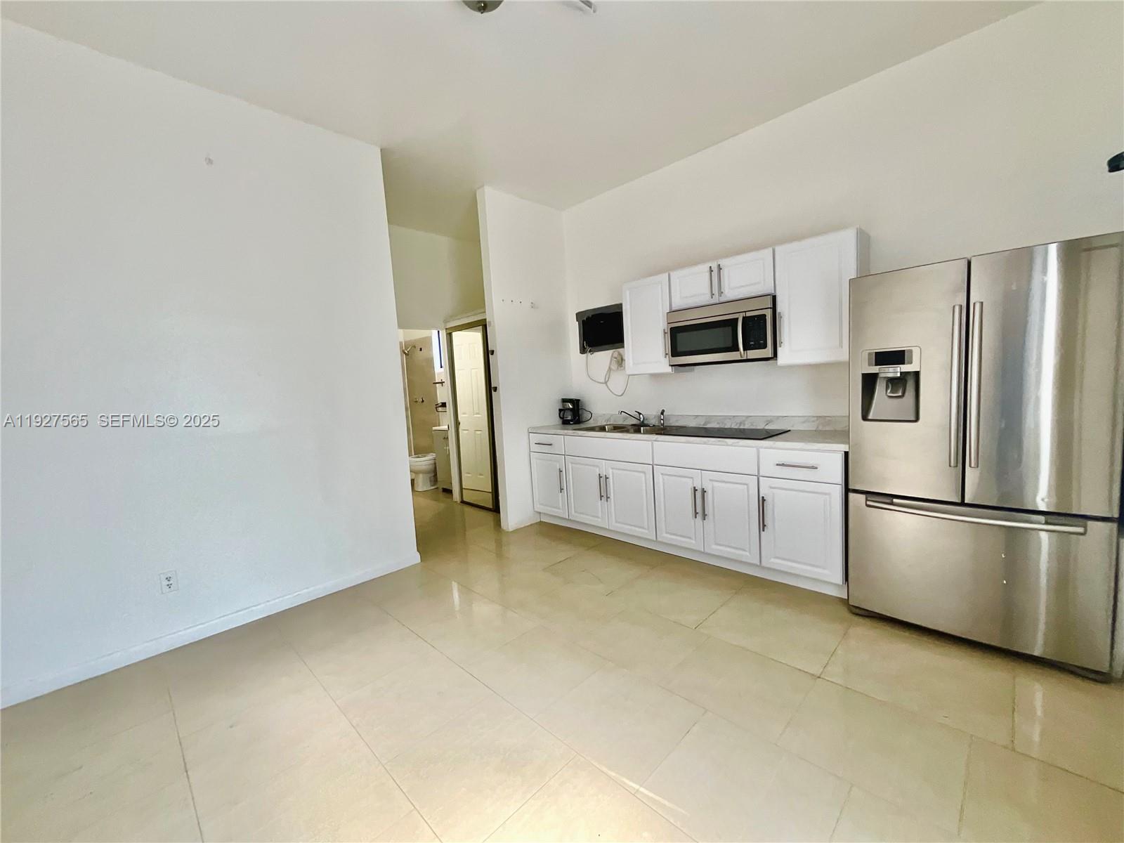 2516 Cleveland Street Hollywood, FL 33020 - Photo 31 of 42 a kitchen with stainless steel appliances a refrigerator sink and microwave