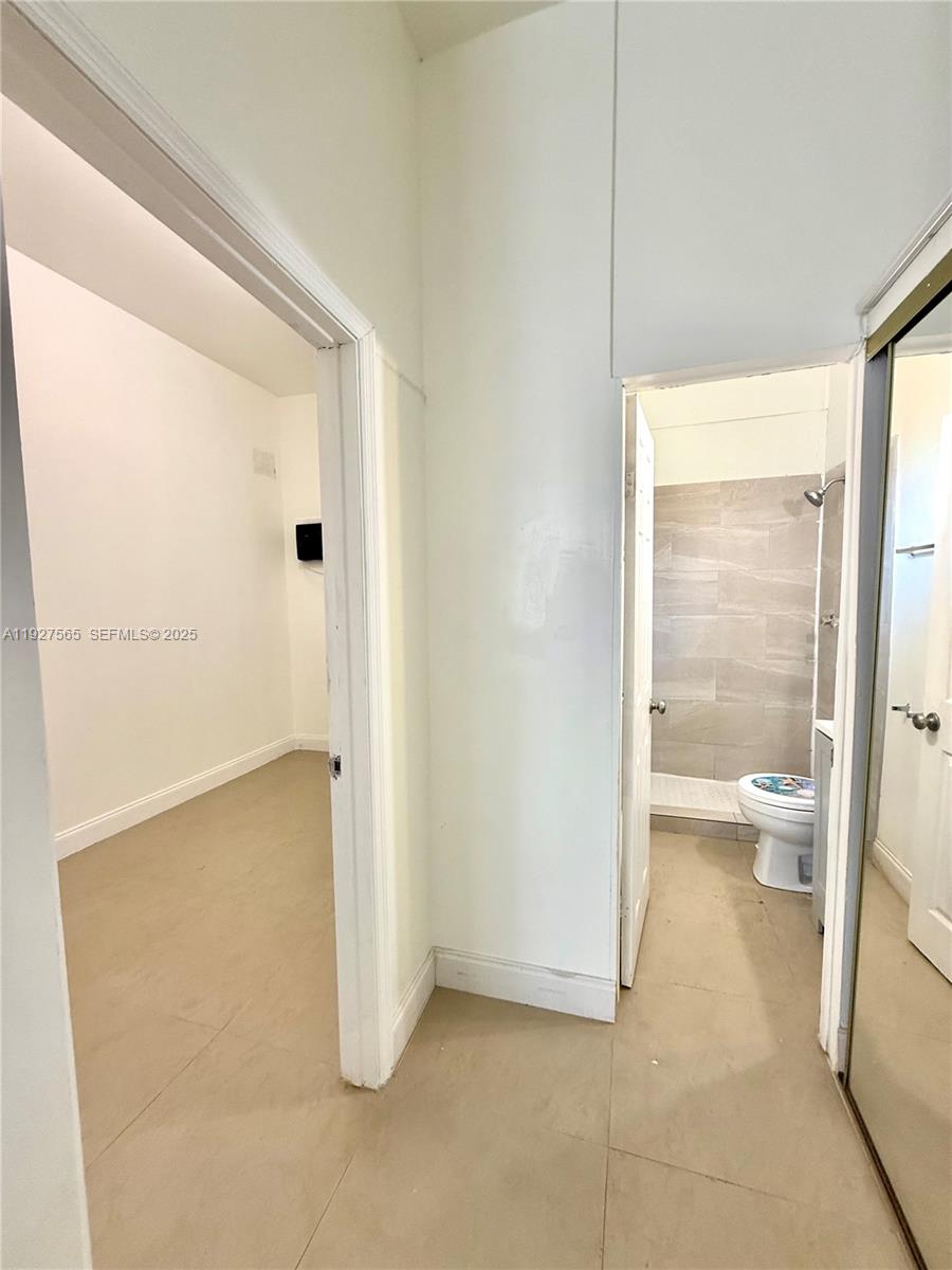 2516 Cleveland Street Hollywood, FL 33020 - Photo 32 of 42 a bathroom with a glass shower door