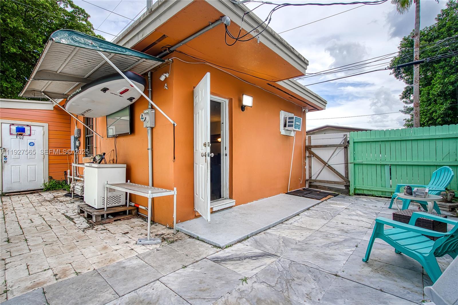 2516 Cleveland Street Hollywood, FL 33020 - Photo 6 of 42 a backyard of a house with chairs and wooden fence