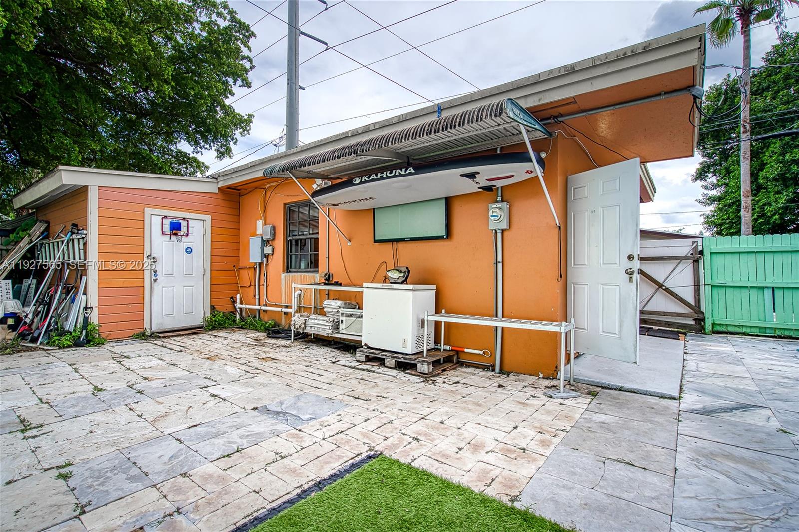 2516 Cleveland Street Hollywood, FL 33020 - Photo 8 of 42 a backyard of a house with barbeque oven table and chairs