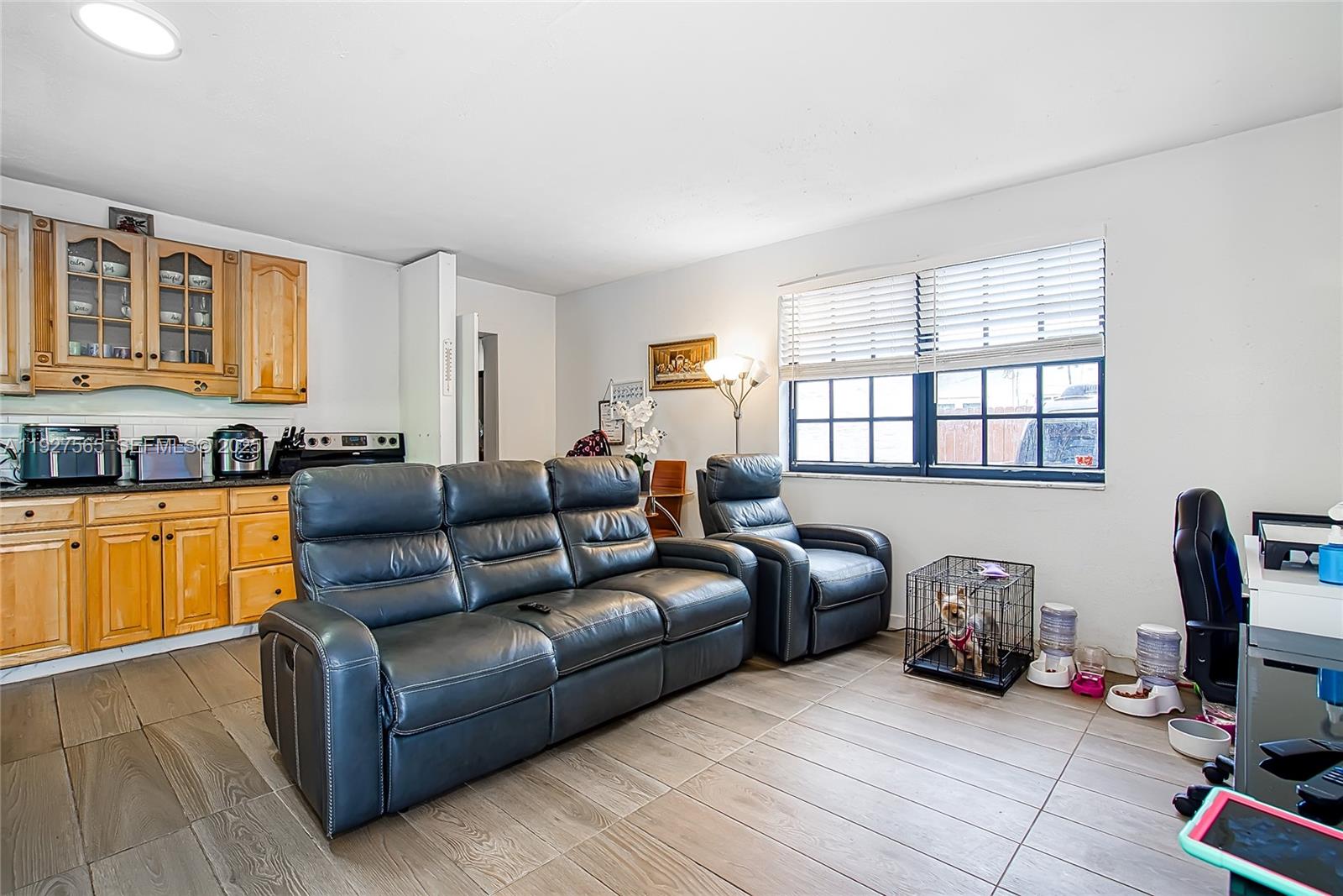 2516 Cleveland Street Hollywood, FL 33020 - Photo 10 of 42 a living room with furniture a flat screen tv and a window