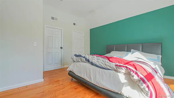a bedroom with a bed and a potted plant