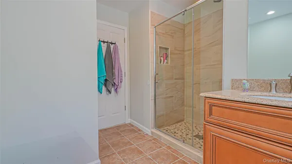 a bathroom with a granite countertop shower and a sink