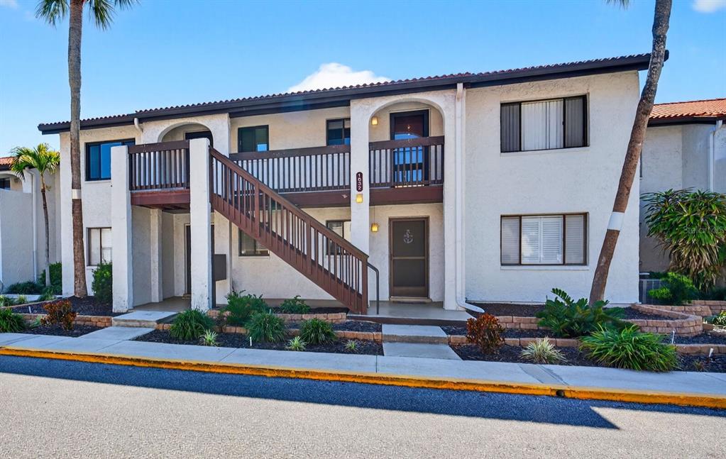 a front view of house with yard and potted plants