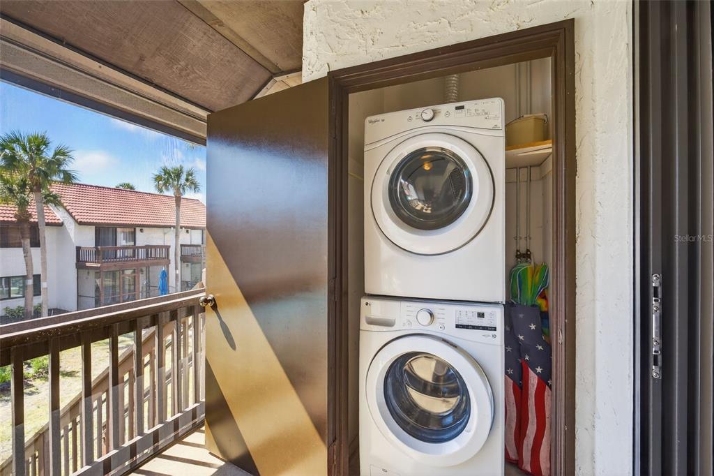 1632 Stickney Point Road, Unit 201 Sarasota, FL 34231 - Photo 23 of 43 a view of a hallway with washer and dryer