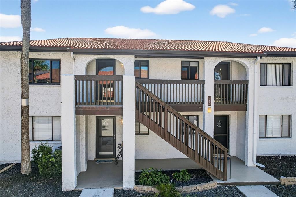 1632 Stickney Point Road, Unit 201 Sarasota, FL 34231 - Photo 25 of 43 front view of a house with a porch