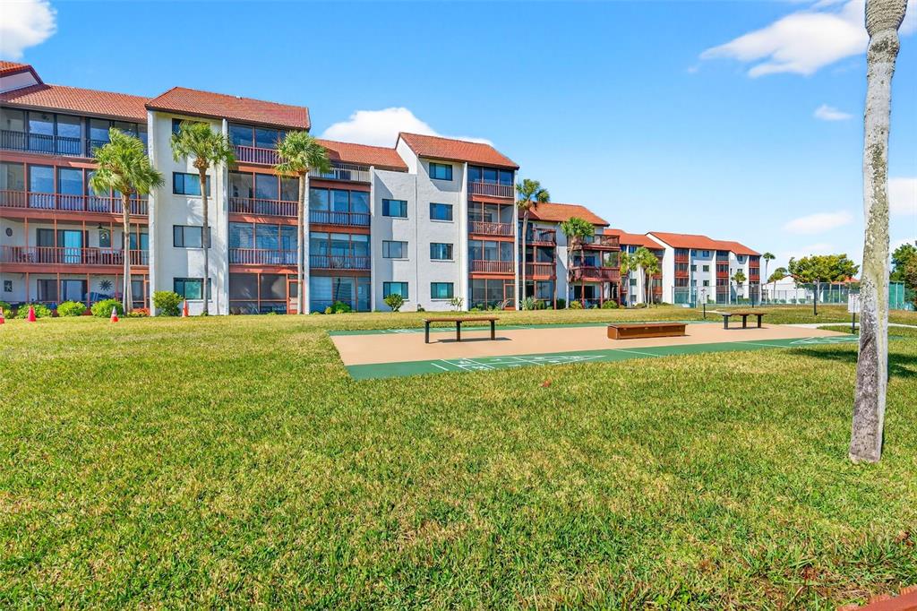1632 Stickney Point Road, Unit 201 Sarasota, FL 34231 - Photo 30 of 43 a front view of building with yard and green space