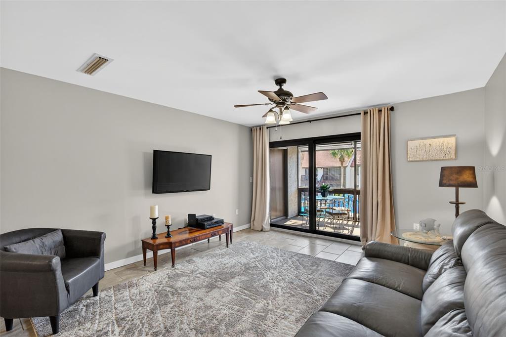 1632 Stickney Point Road, Unit 201 Sarasota, FL 34231 - Photo 3 of 43 a living room with furniture and a flat screen tv