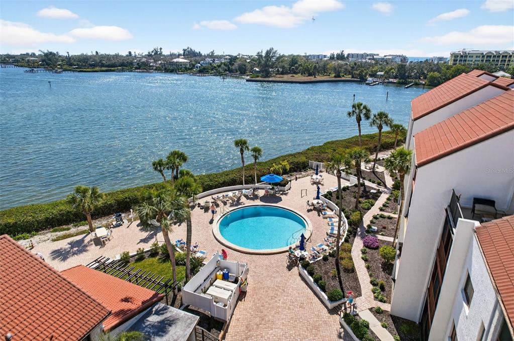 1632 Stickney Point Road, Unit 201 Sarasota, FL 34231 - Photo 33 of 43 a view of a balcony with outdoor seating and lake view