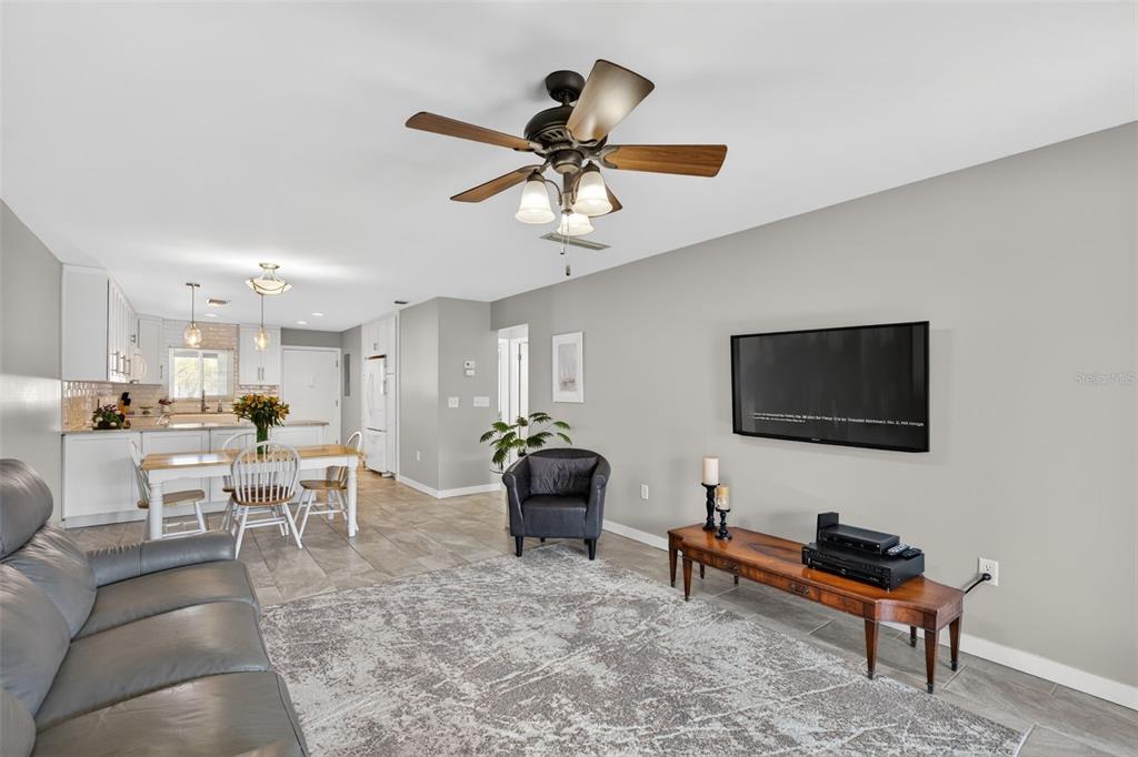 1632 Stickney Point Road, Unit 201 Sarasota, FL 34231 - Photo 4 of 43 a living room with furniture and a flat screen tv