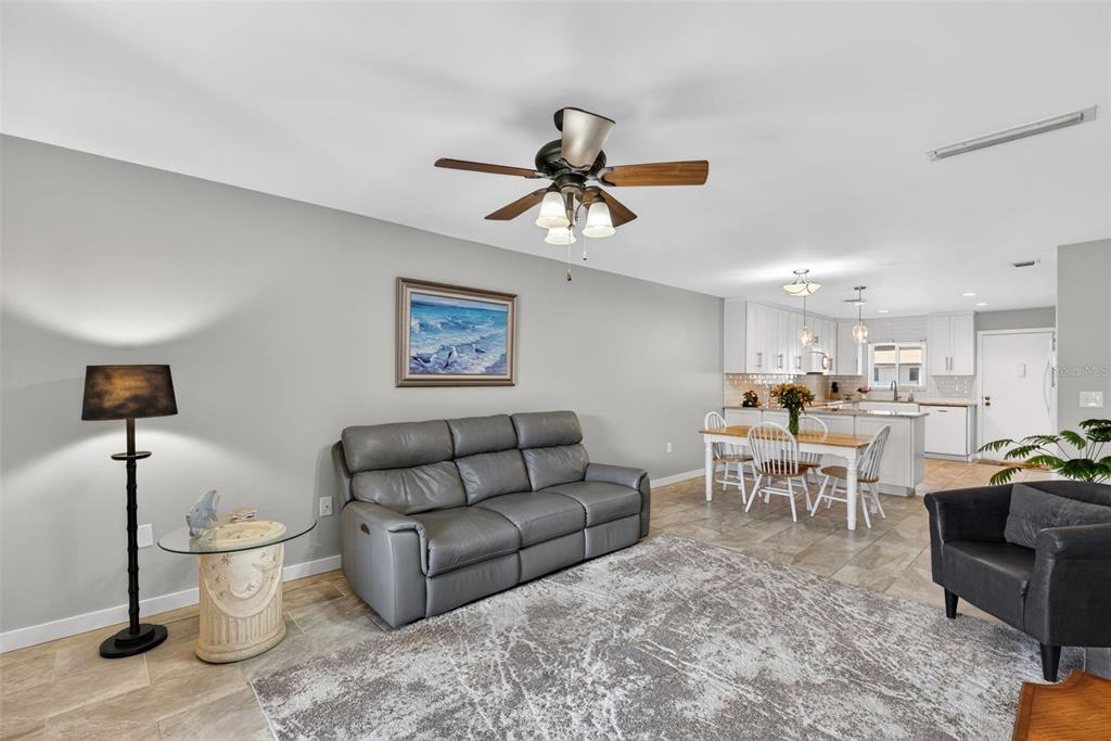 1632 Stickney Point Road, Unit 201 Sarasota, FL 34231 - Photo 5 of 43 a living room with furniture a rug and white walls