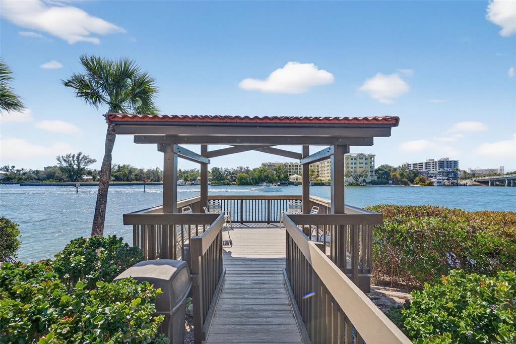 1632 Stickney Point Road, Unit 201 Sarasota, FL 34231 - Photo 6 of 43 a view of a balcony with wooden floor next to a lake