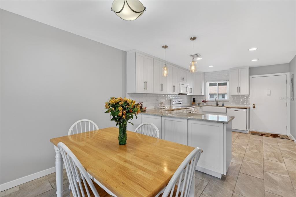 1632 Stickney Point Road, Unit 201 Sarasota, FL 34231 - Photo 8 of 43 a kitchen with a table and chairs