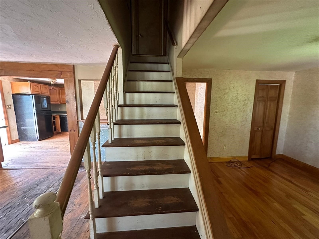133 Salem Road Billerica, MA 01821 - Photo 17 of 32 a view of staircase with wooden floor and white walls
