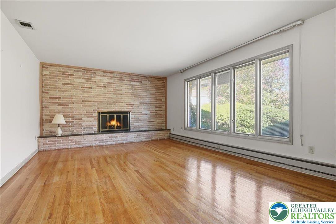 4395 East Texas Road Allentown, PA 18103 - Photo 14 of 81 a view of an empty room with wooden floor and a window