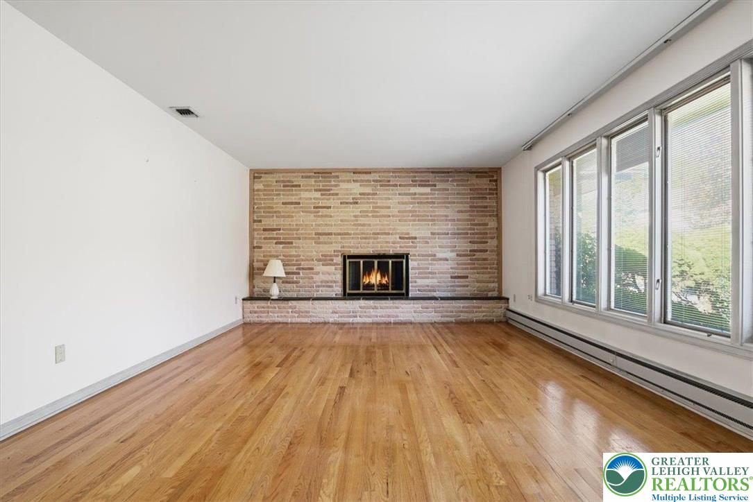 4395 East Texas Road Allentown, PA 18103 - Photo 15 of 81 a view of empty room with wooden floor and fireplace