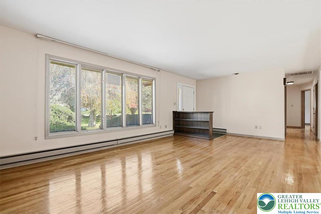 4395 East Texas Road Allentown, PA 18103 - Photo 17 of 81 a view of an empty room with a window and wooden floor